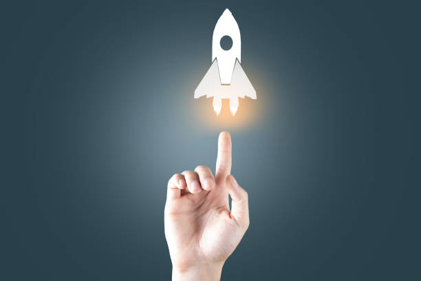 istock Startup business concept, Businessman holding icon transparent rocket 1488972828