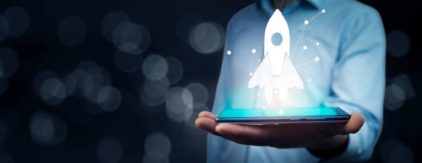 istock Startup business concept, Businessman holding icon transparent rocket 1488972843