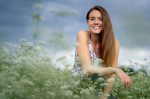 Beautiful natural woman among white flowers