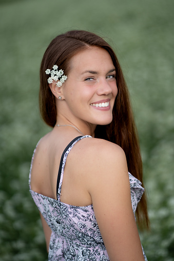 Smiling young woman in the grassfield