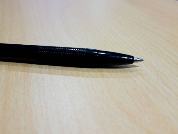 istock black ballpoint pen on wooden desk 1488975475