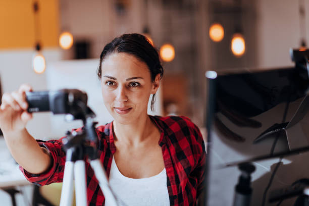 istock A young woman using a camera to present her business with online clients 1488977544