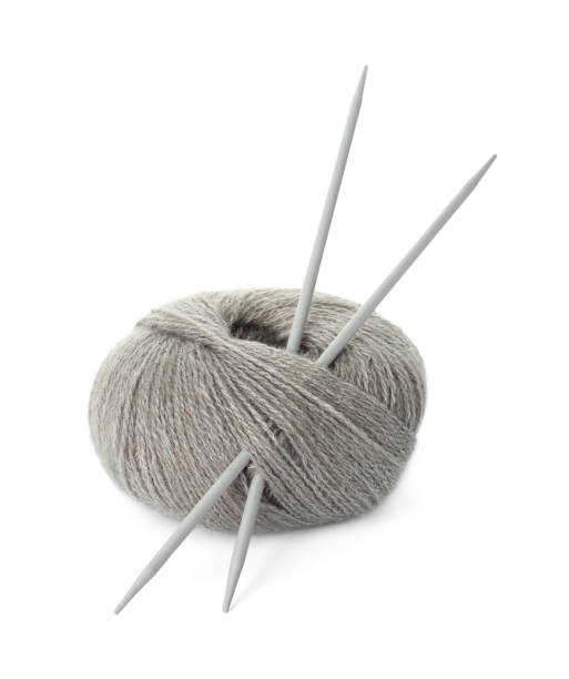 istock Grey woolen knitting yarn and needles on white background 1488978582