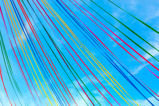 Colored ribbons in the sky . Festive background