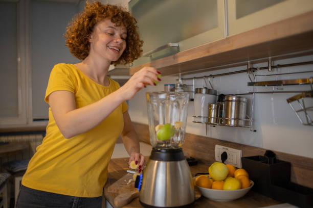 istock Young woman making juice at home 1488989870