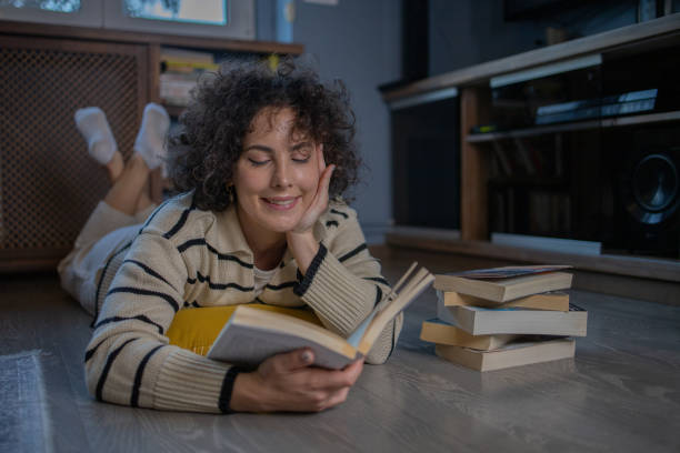 istock Woman relaxing and reading a book 1488989884