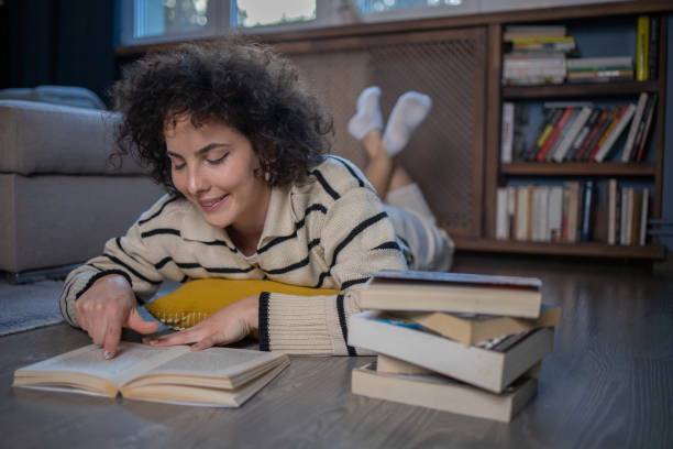 istock Woman relaxing and reading a book 1488989887