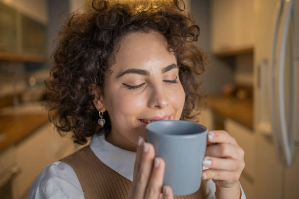 istock Woman having coffee and relaxing at home 1488990067