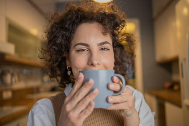 istock Woman having coffee and relaxing at home 1488990072