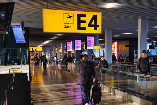 amsterdam, netherlands - 18 October 2022: a sign hanging on the ceiling in a hall of an airport terminal building indicates the direction for the passenger for carry-on luggage