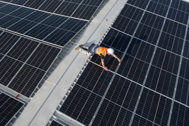 istock Technician on a roof repairing solar panels. 1488990861