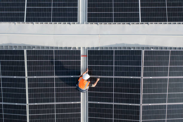 istock Technician on a roof repairing solar panels. 1488990883