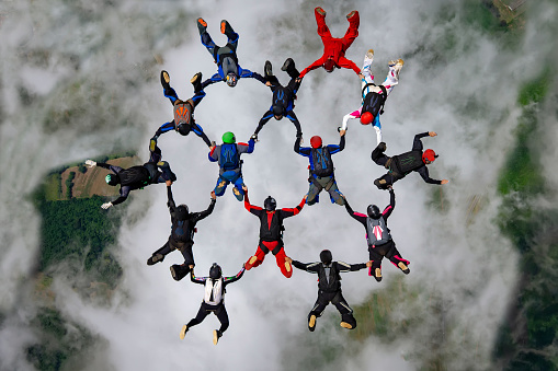 Skydivers above the clouds