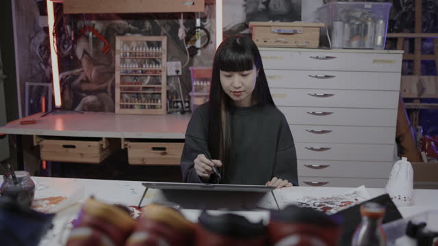 Japanese artist working in her creative studio
