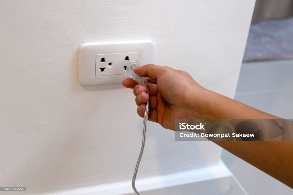 Plug The Socket Hand Insert A Plug Into Socket Stock Photo - Download Image Now ...