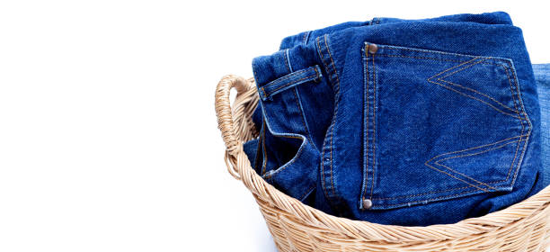 istock Jeans in laundry basket on white background. 1489009814