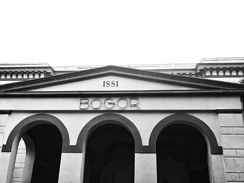 Exterior of front gate view of Bogor train station building, West Java, Indonesia in black and white
