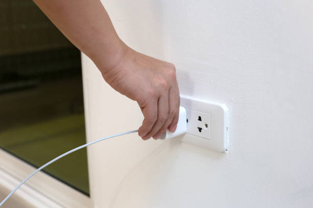 istock Hand insert a plug of the phone charger into socket. 1489010965