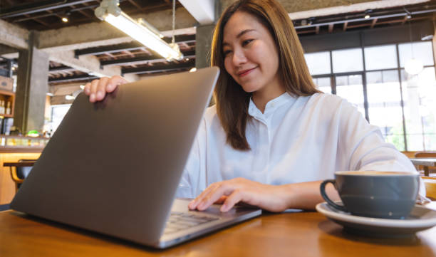 istock A young woman opening or closing laptop computer, getting ready for work, finished work in office 1489017828