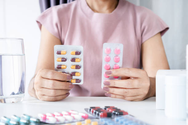 istock Antibiotic vs. Antibiotic Anti-Inflammatory Medication: Asian Woman's Comparison and Confusion 1489022237