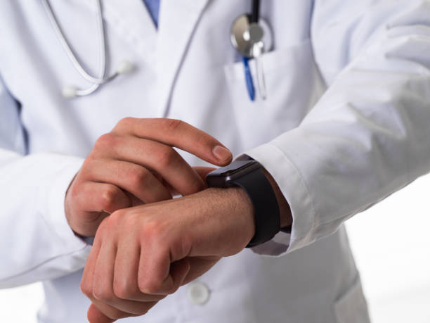 istock Doctor in suit with stethoscope using smart watch while isolated on white background 1489025421