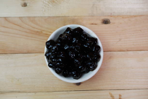 istock selective focus to Pile of black tapioca pearls for bubble tea on white bowl. soft focus 1489027929