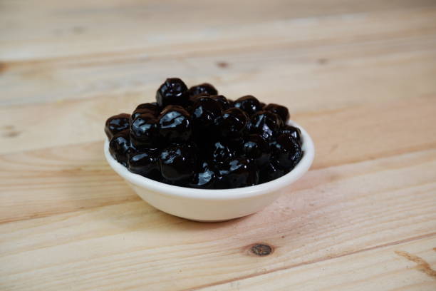 istock selective focus to Pile of black tapioca pearls for bubble tea on white bowl. soft focus 1489027937