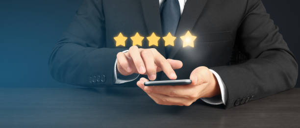 istock Man holding smartphone device and touching screen with five star rating feedback 1489028227