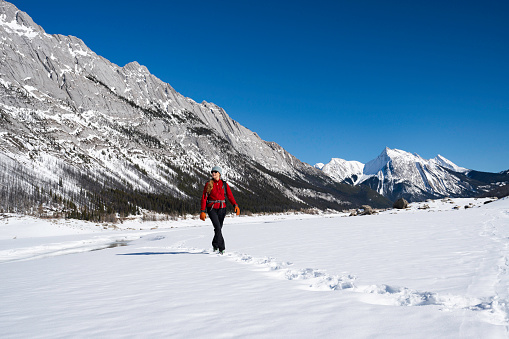 Solo hiker in winter, Jasper National Park, Jasper, Alberta, Canada