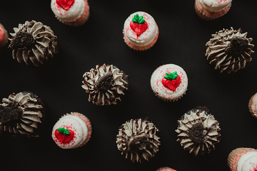 Background image of chocolate and strawberry cupcakes