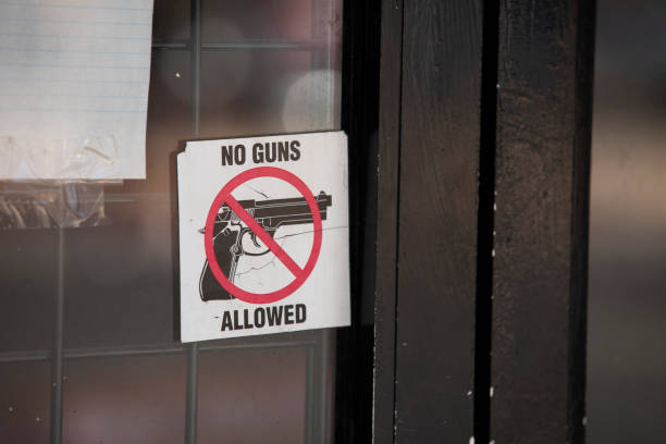 No Guns Allowed Graphic Nogales, Arizona, USA - May 29, 2022: A sticker on a business door communicates that no guns are allowed in the building. nogales arizona stock pictures, royalty-free photos & images