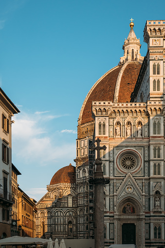 Historical landmark of Italy is the amazing Florence Cathedral of St. Mary of the Flower with a complex ornament and composition on a sunny summer evening. Concept of medieval architecture in Europe.