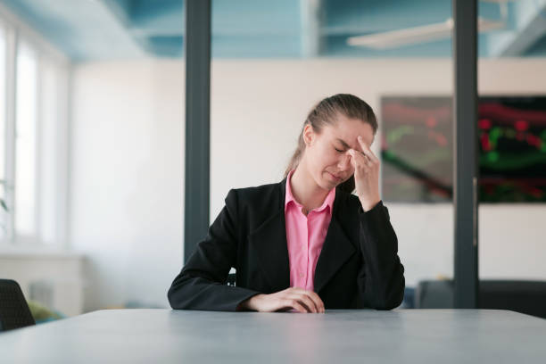 istock Tired stressed businesswoman feeling strong headache massaging temples exhausted from overwork, fatigued overwhelmed lady executive worker suffering from pain in head or chronic migraine in office. 1489045128