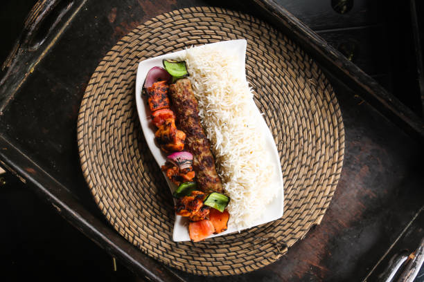 chelo kabab or chello kebab with chicken tikka and rice served in dish isolated on red mat top view on table arabic food - chello imagens e fotografias de stock