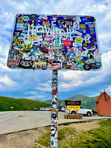 Aspen, Colorado, USA - July 16, 2021: A sign at Independence Pass is covered in stickers placed there by tourists.