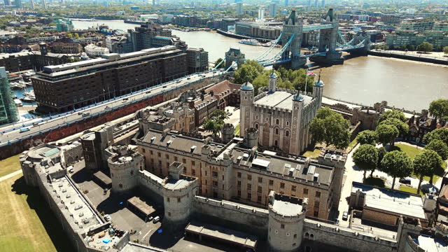 AERIAL shot over of the Fortress of The Tower of London and the Tower Bridge