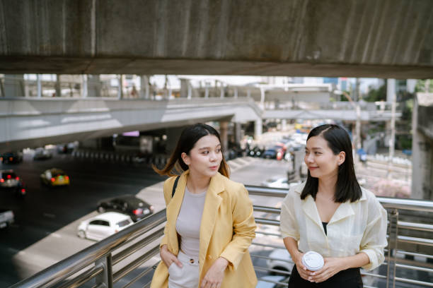 istock Two Asian Women Walking Back to Work Together After Lunch. 1489049869