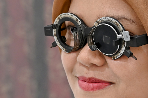 Close Up Woman using eye test kit