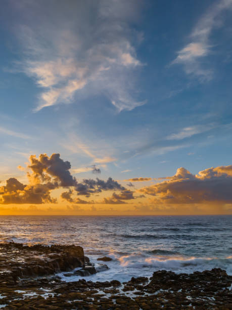 istock Sunrise and clouds over the ocean and rock platform 1489050516