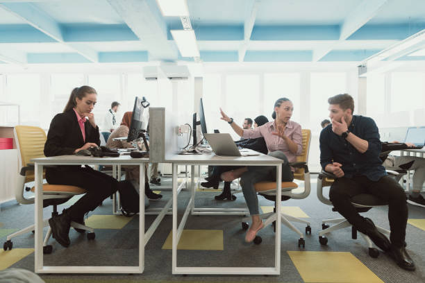 Two business people with wheelchair in the office working together.