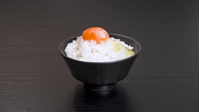 put the egg yolk on top of the rice