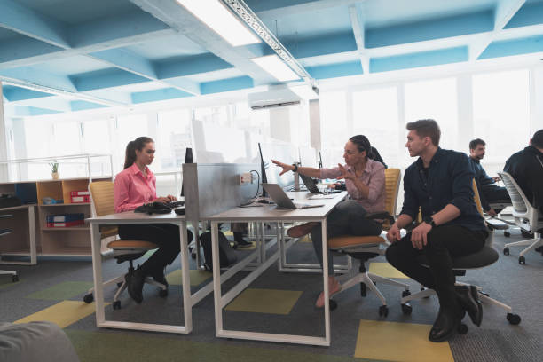 istock Collaborative process of multicultural skilled young business team during brainstorming meeting in office.Diverse group of young people dressed in formal wear cooperating on developing design project. 1489051599