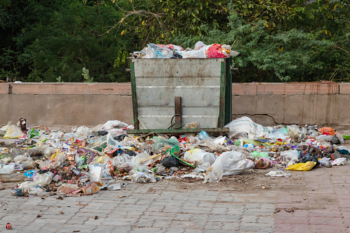 open garbage dust bin liter with plastic begs and waste items at day from different angle
