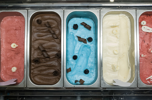 Italian gelato of various flavors in ice cream parlor.