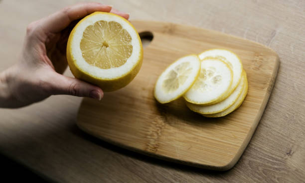 istock close-up of a hand holding a lemon. 1489056067