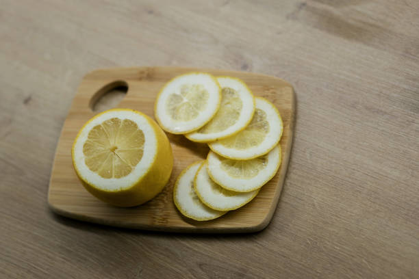 Lemon slices on the old wooden table. Fresh slice yellow lemon
