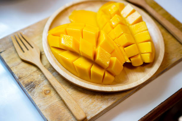 istock A side view shows sliced ripe mangoes beautifully placed on a plate, ready to be served. 1489056672