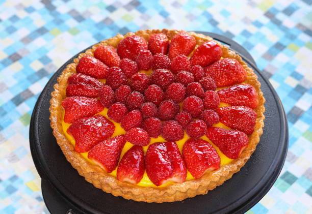 istock fruits cake decorated with berries and cream on black tray 1489057494