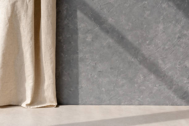 istock Empty gray concrete wall, beige stone floor, linen curtain, geometric sunlight shadow, blank home room interior design background in Scandinavian style 1489057520