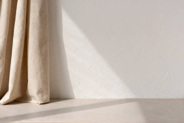 istock Neutral modern empty room with sunlight shadow, white blank wall background, beige linen curtain and stone floor or tabletop, aesthetic minimalist interior design template 1489058271